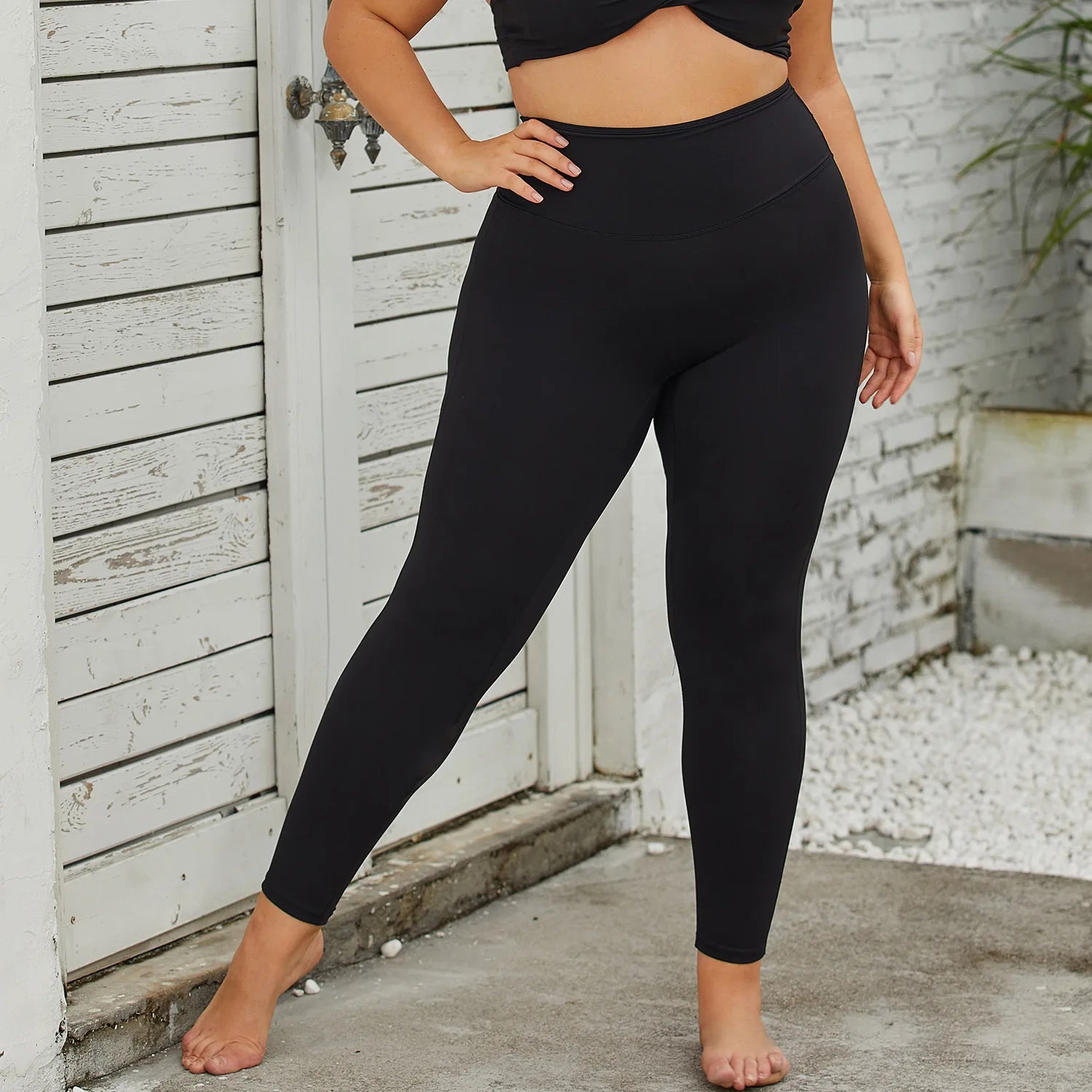 a woman in a black crop top and leggings