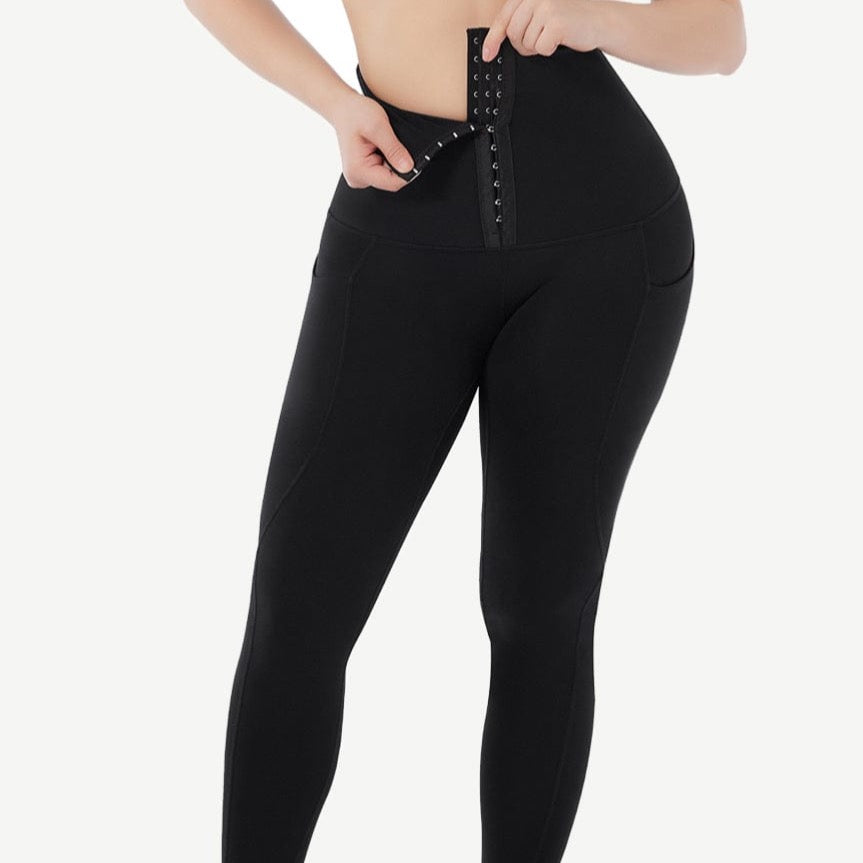 a woman in black sports bra top and leggings