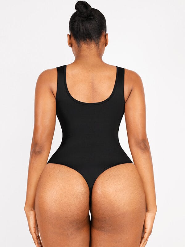 a woman in a black bodysuit with her butt showing