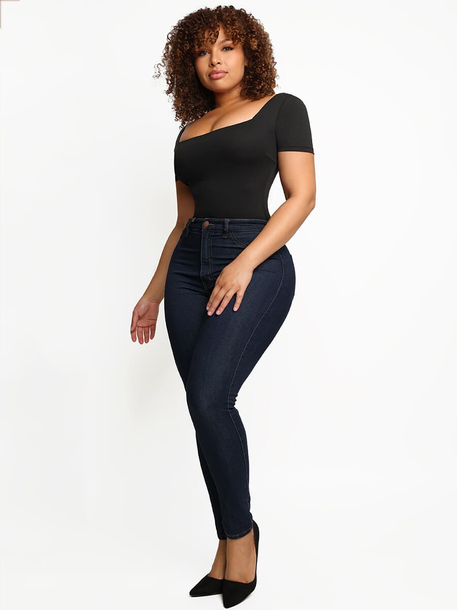 a woman in a black top and jeans
