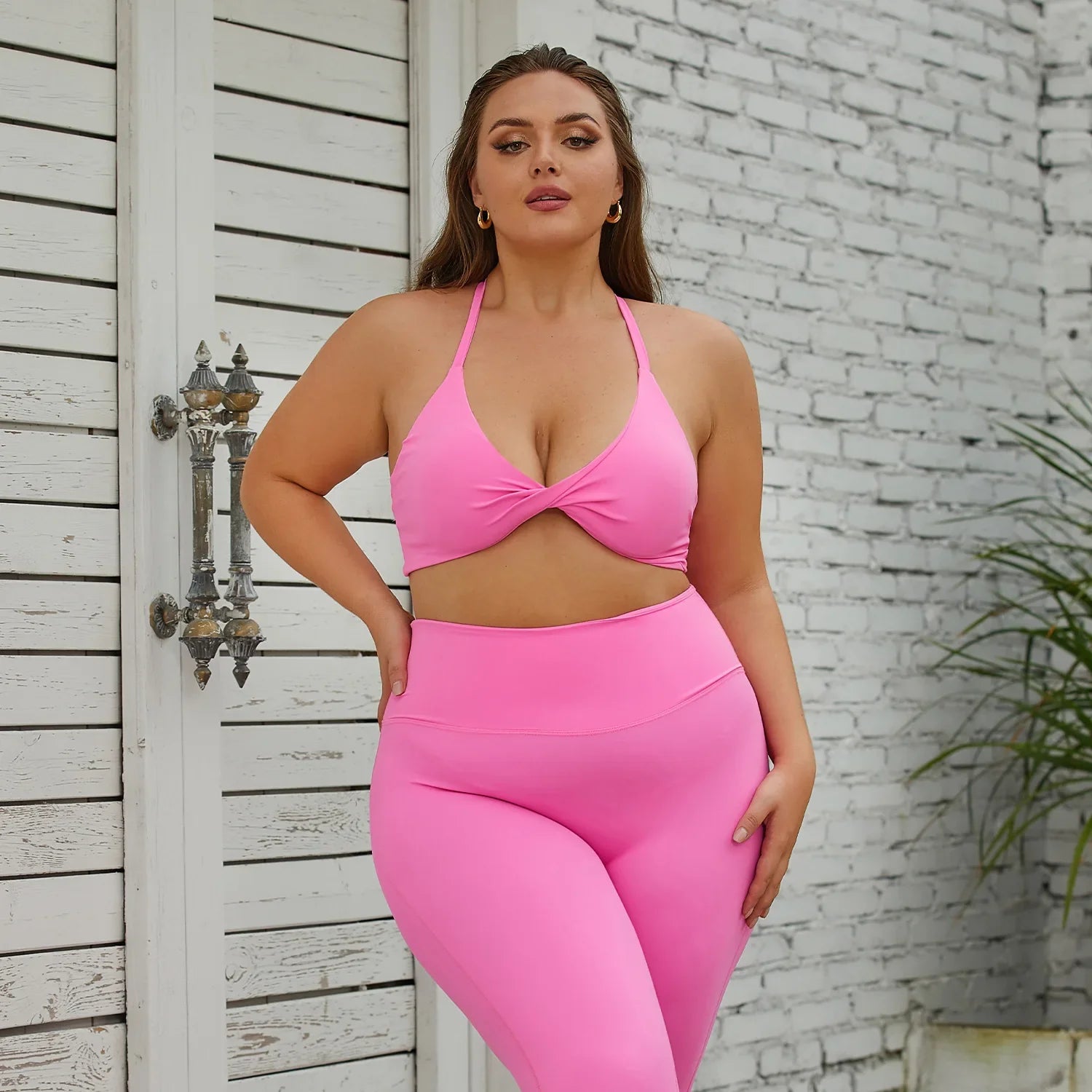 a woman in a pink bikini top and matching leggings