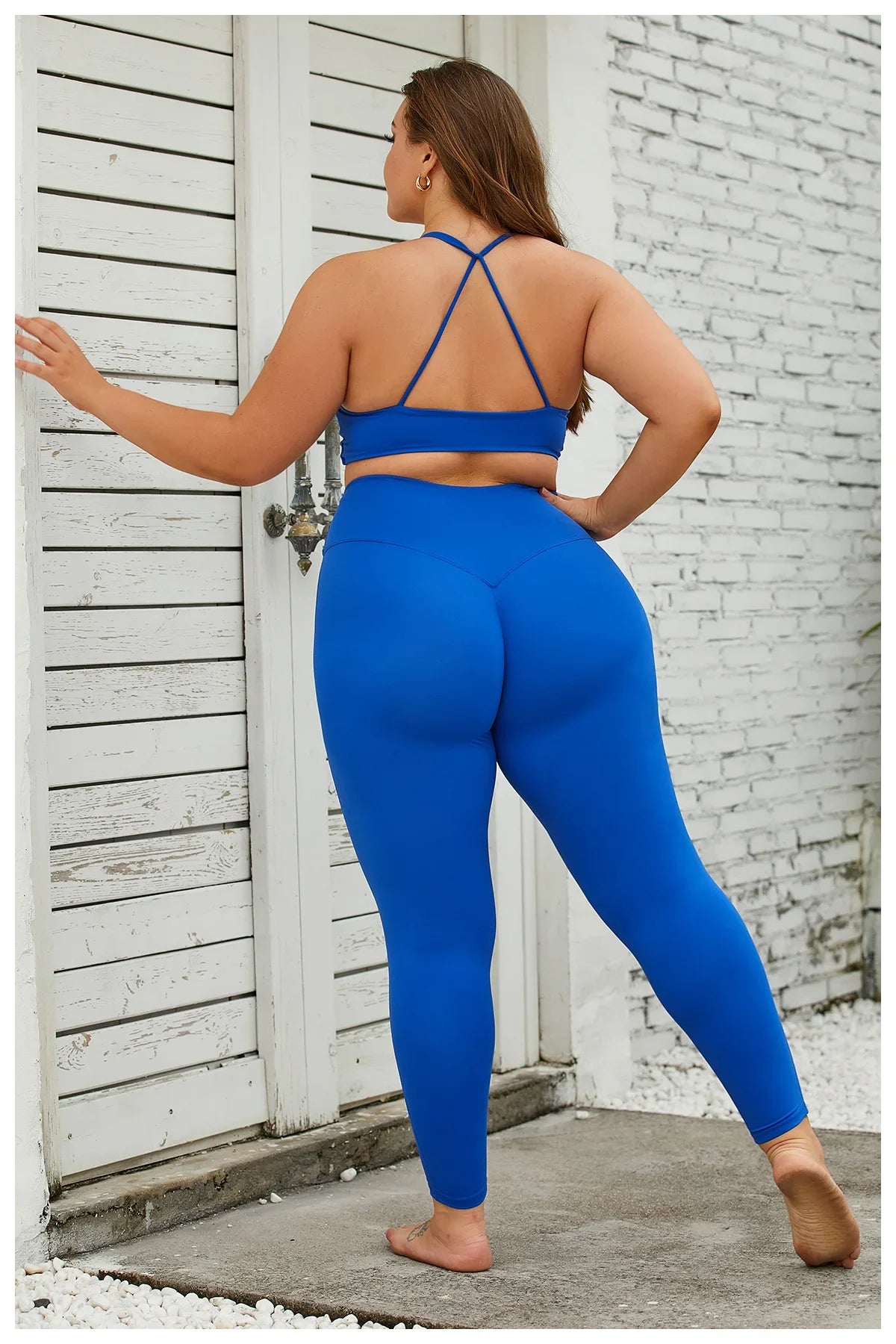 a woman in a blue sports bra top and leggings