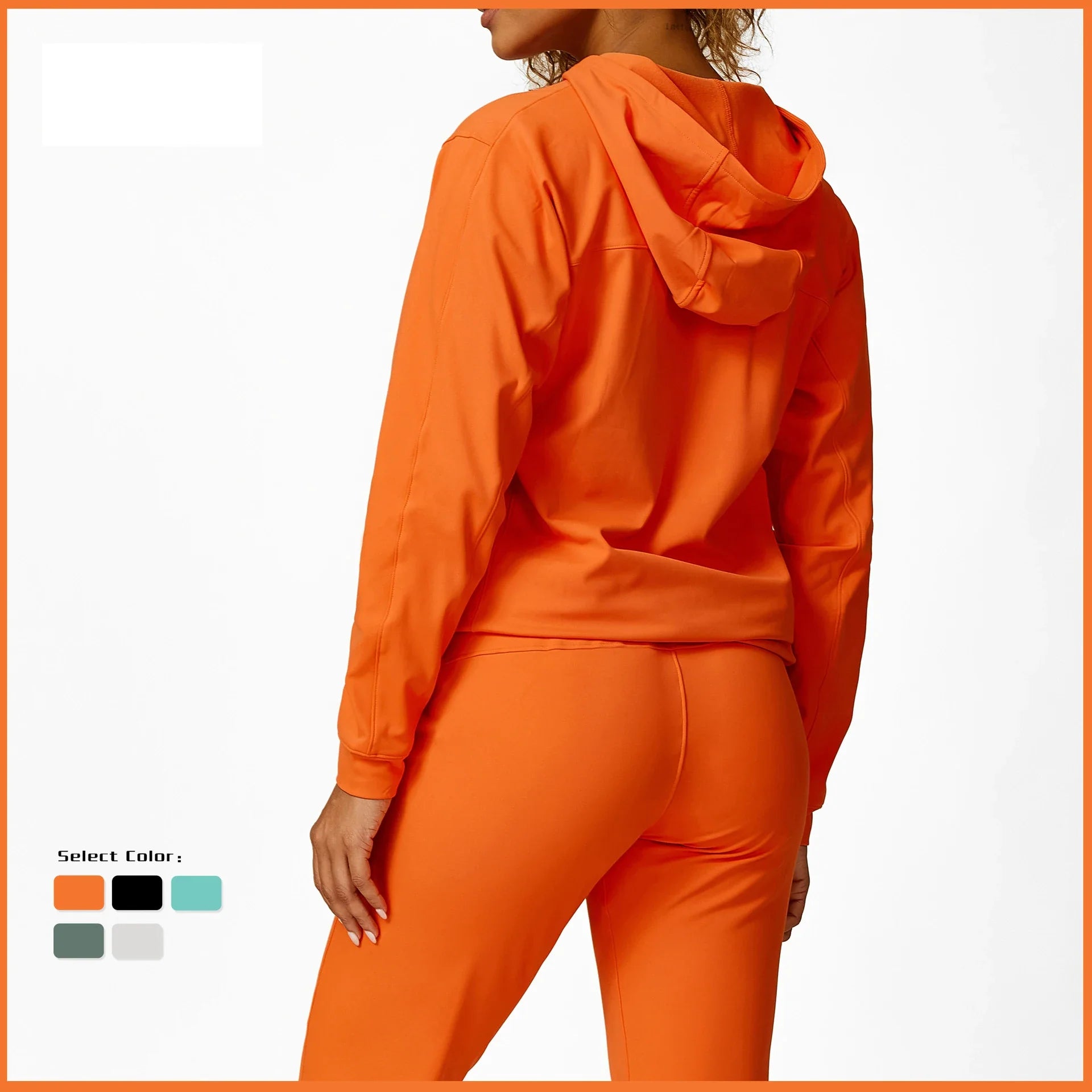 a woman wearing an orange hoodie and matching pants