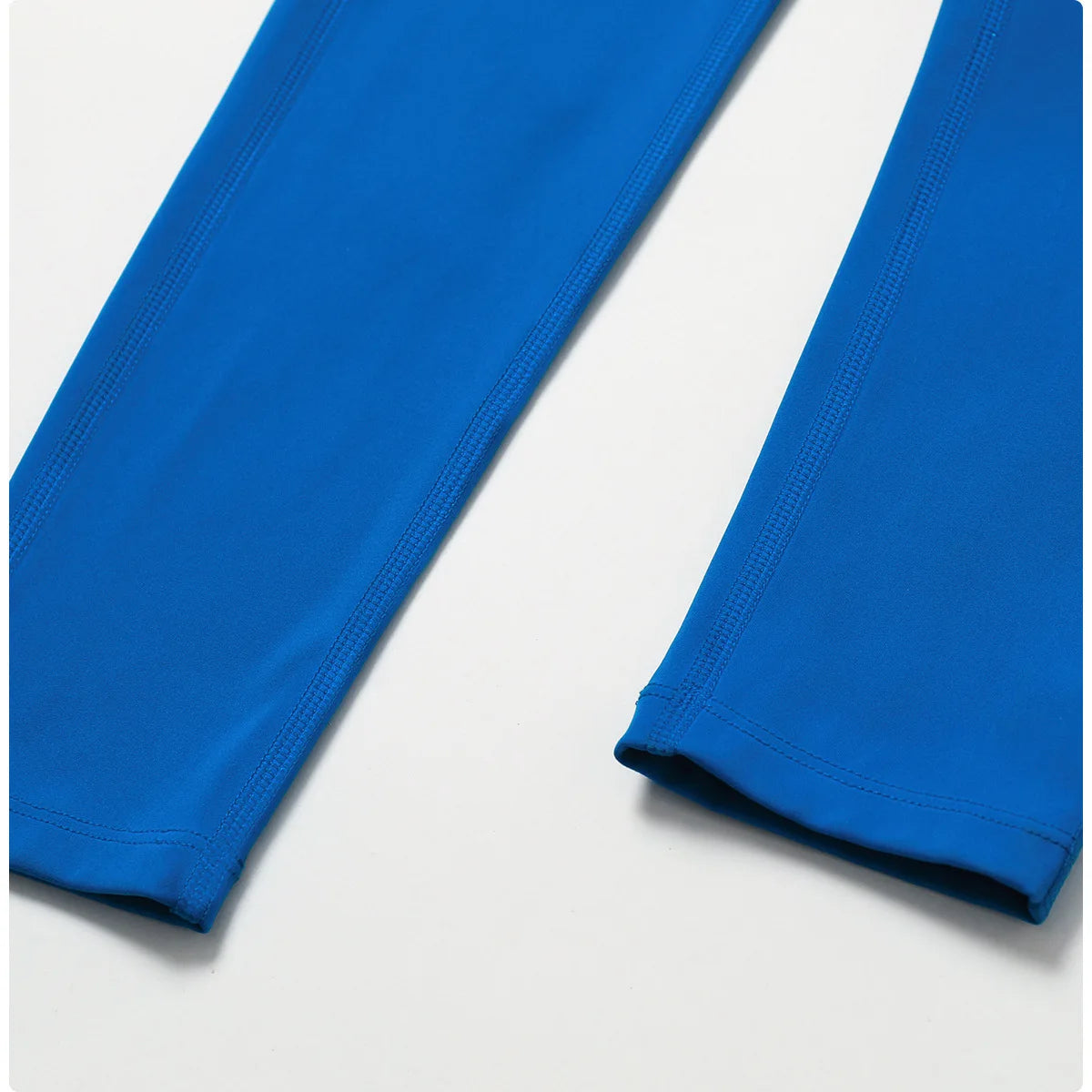 a pair of blue leggings on a white surface