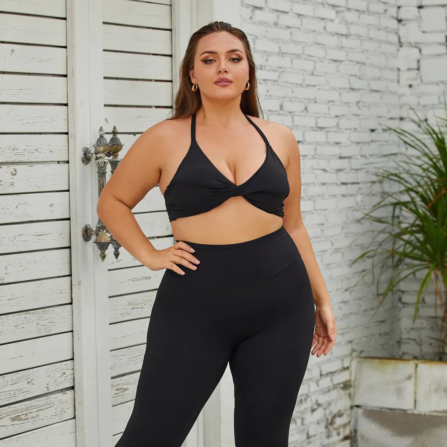 a woman in a black sports bra top and leggings