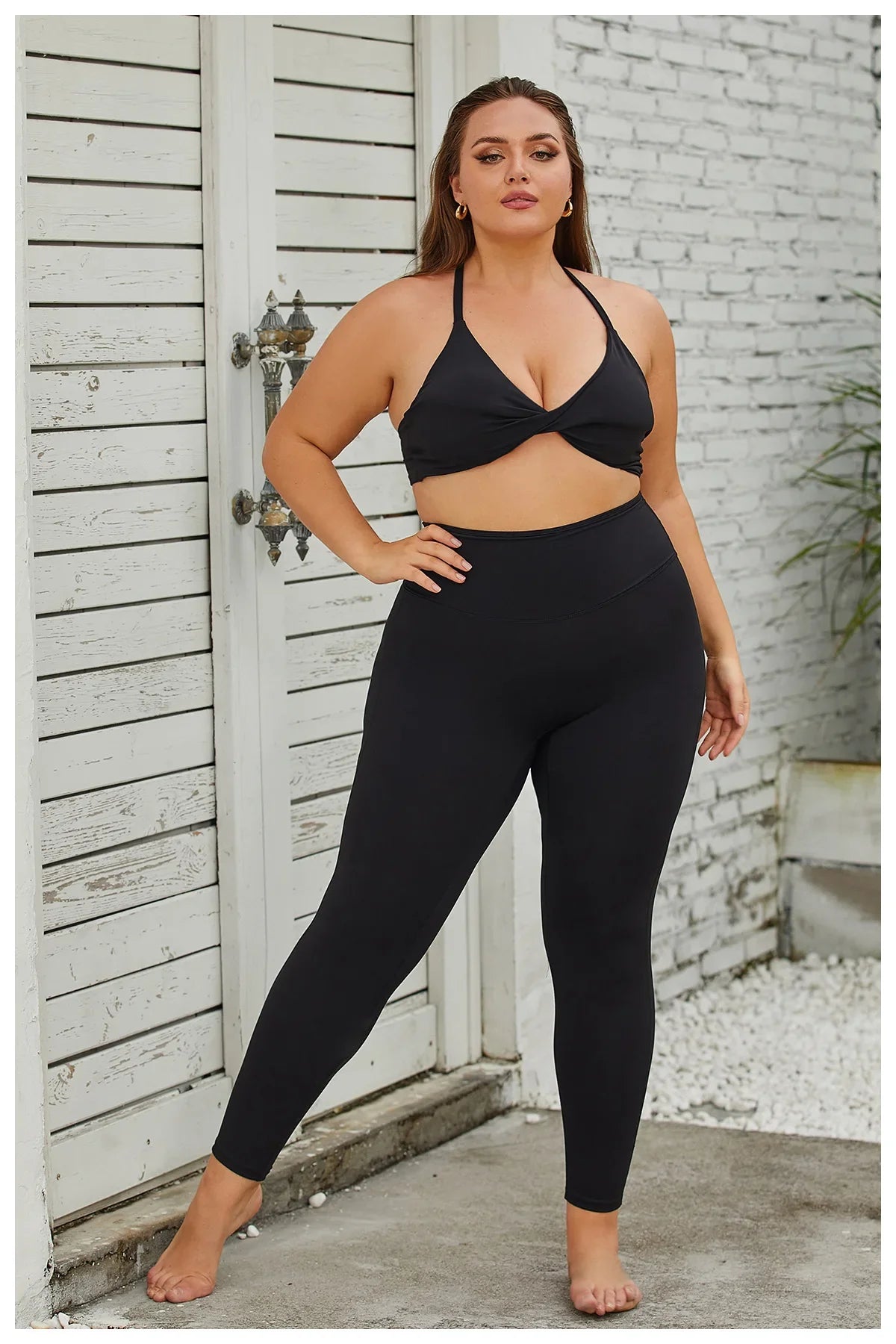 a woman in a black sports bra top and leggings