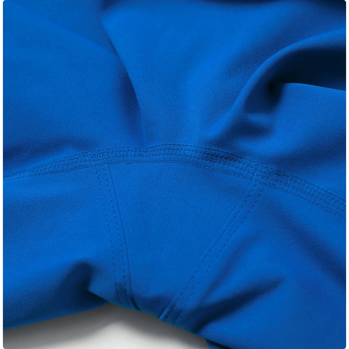 a close up of a blue jacket on a white surface