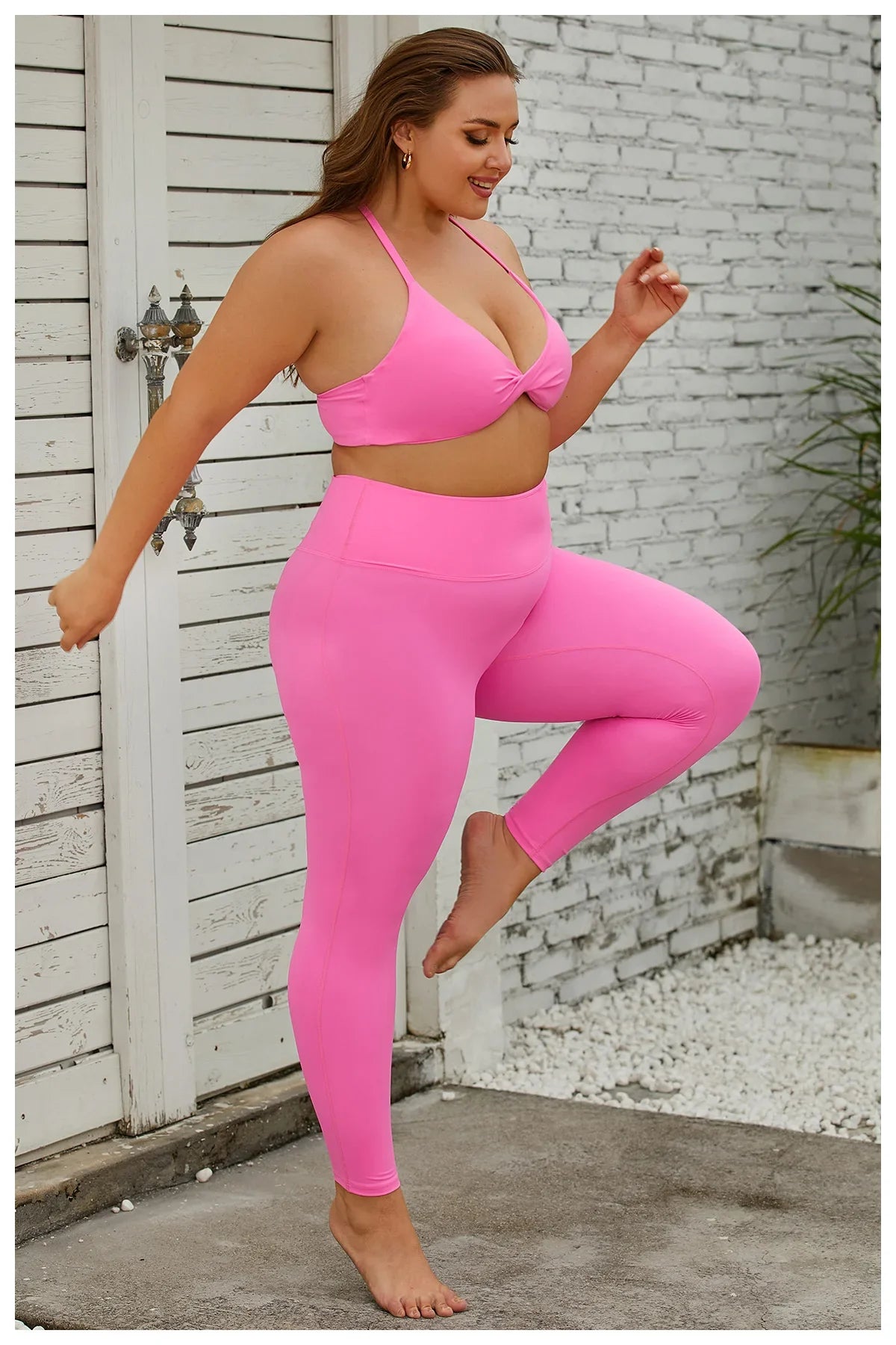 a woman in a pink sports bra top and leggings