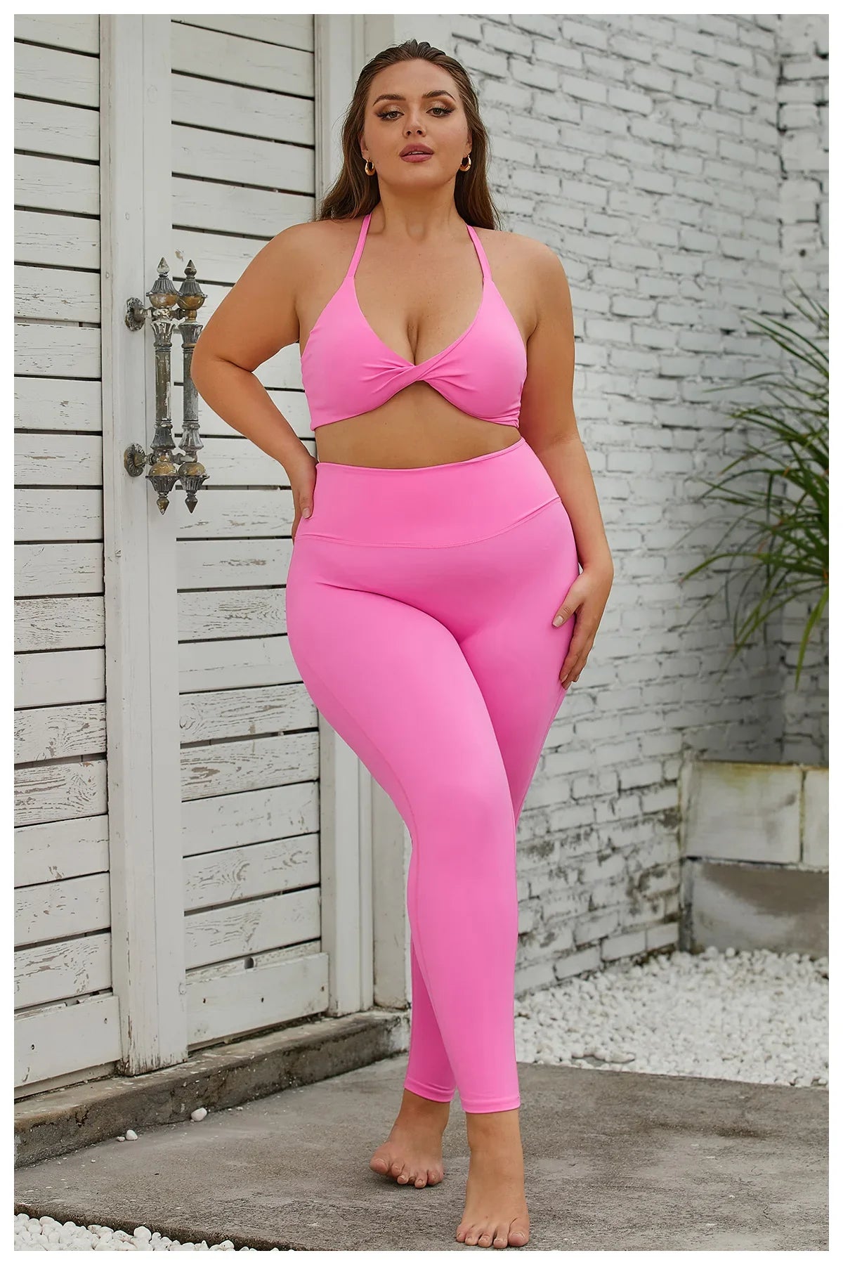 a woman in a pink sports bra top and leggings