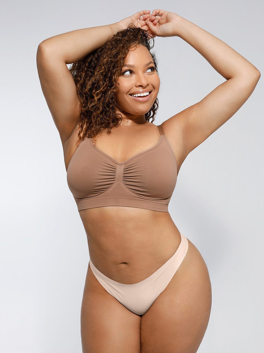 a woman in a tan bikini top posing for a picture