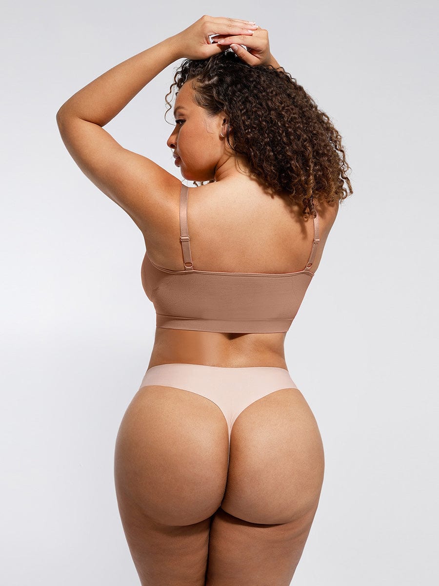 a woman in a tan bikini top and panties